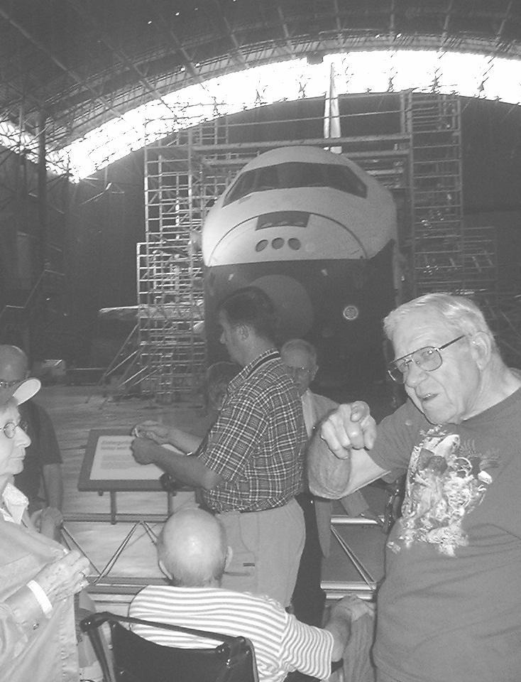 ECD members chatting while viewing a retired space shuttle