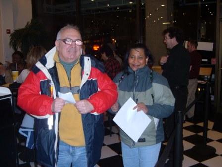 Ron Farris standing and smiling along with Iris Gomes in foyer of a restaurant where fundraiser was held