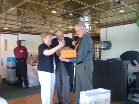 Rudy and Marlene Hines open gift held by Steve Holst