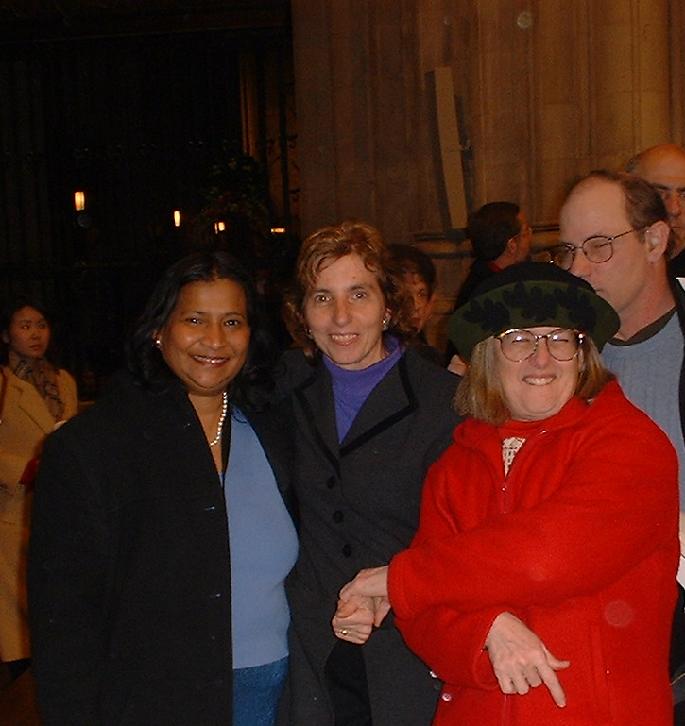 Iris Gomes, Nancy Connors and Shelley Simms smiling for the camera after Christmas Eve service at Cathedral