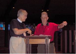 The Rev. Barbara Allen and ECD Treasurer David Early talking intently at conference