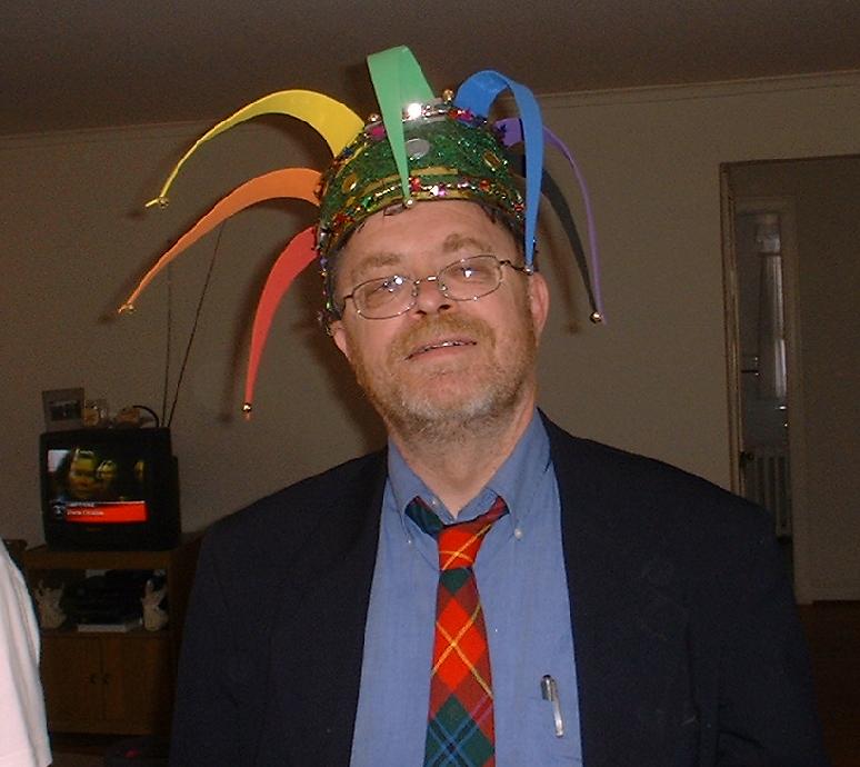 Ted Blake wearing a tartan tie (sort of traditional for Episcopalians) and a colorful Jester's cap (not quite so traditional)