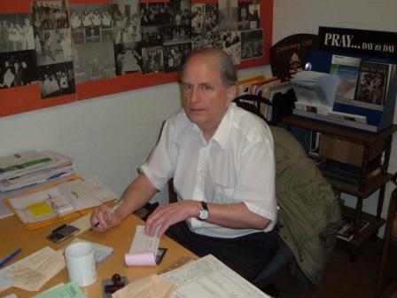 teller John Ricciardi working at desk