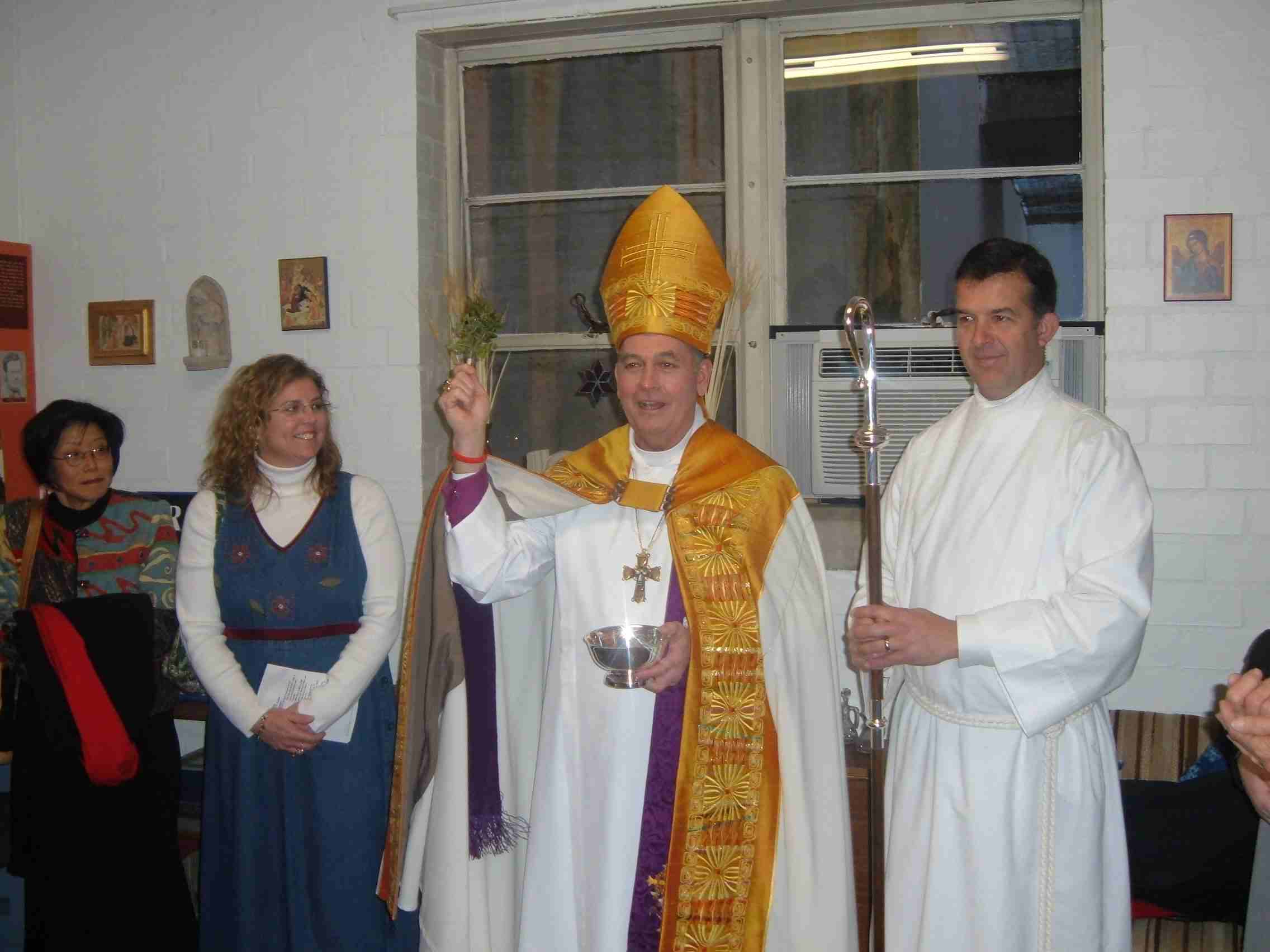 Bishop Chane asperges the renovated St. Barnabas office 