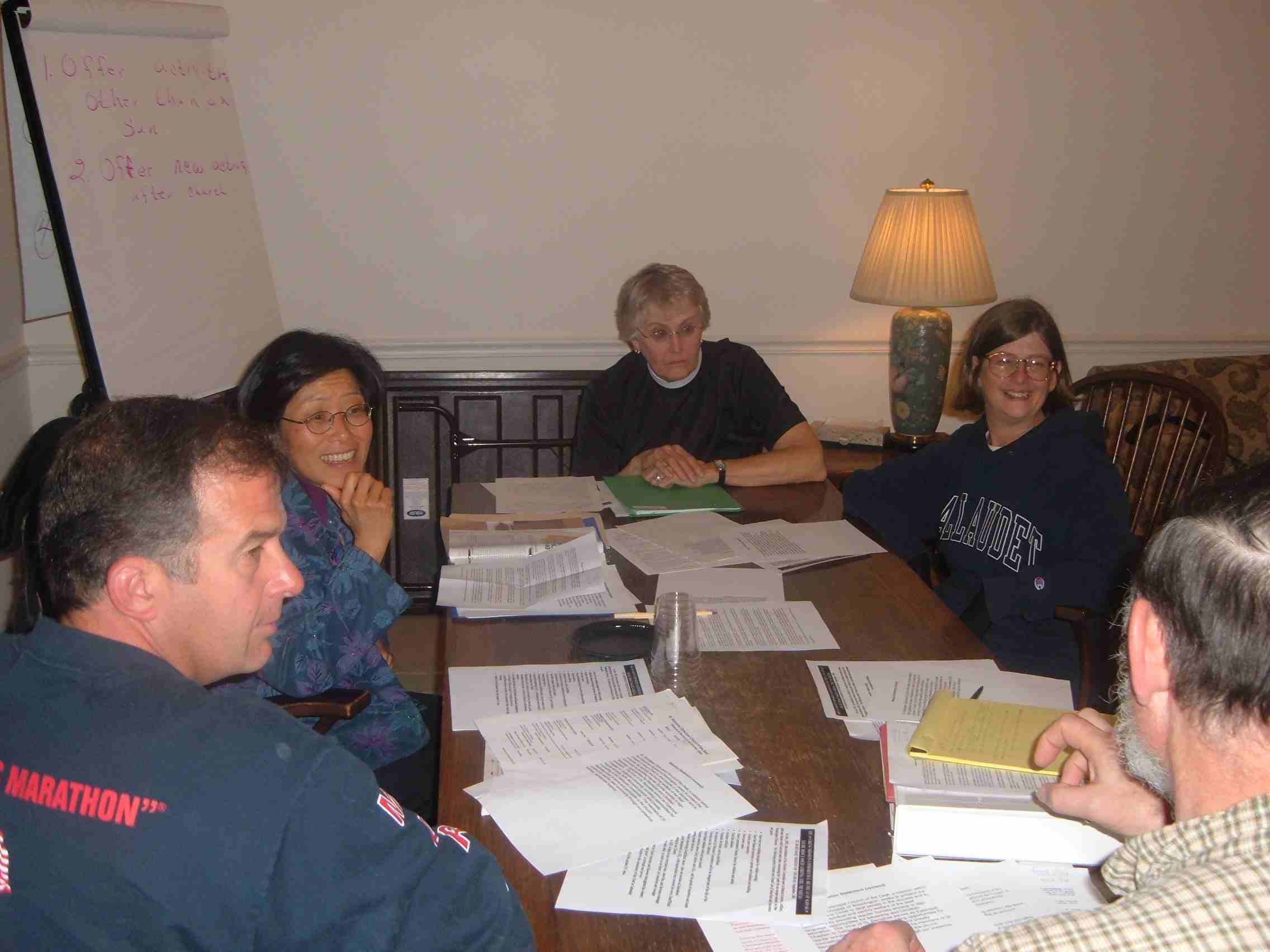 St. Barnabas Mission Committee members talking around table at Cathedral College