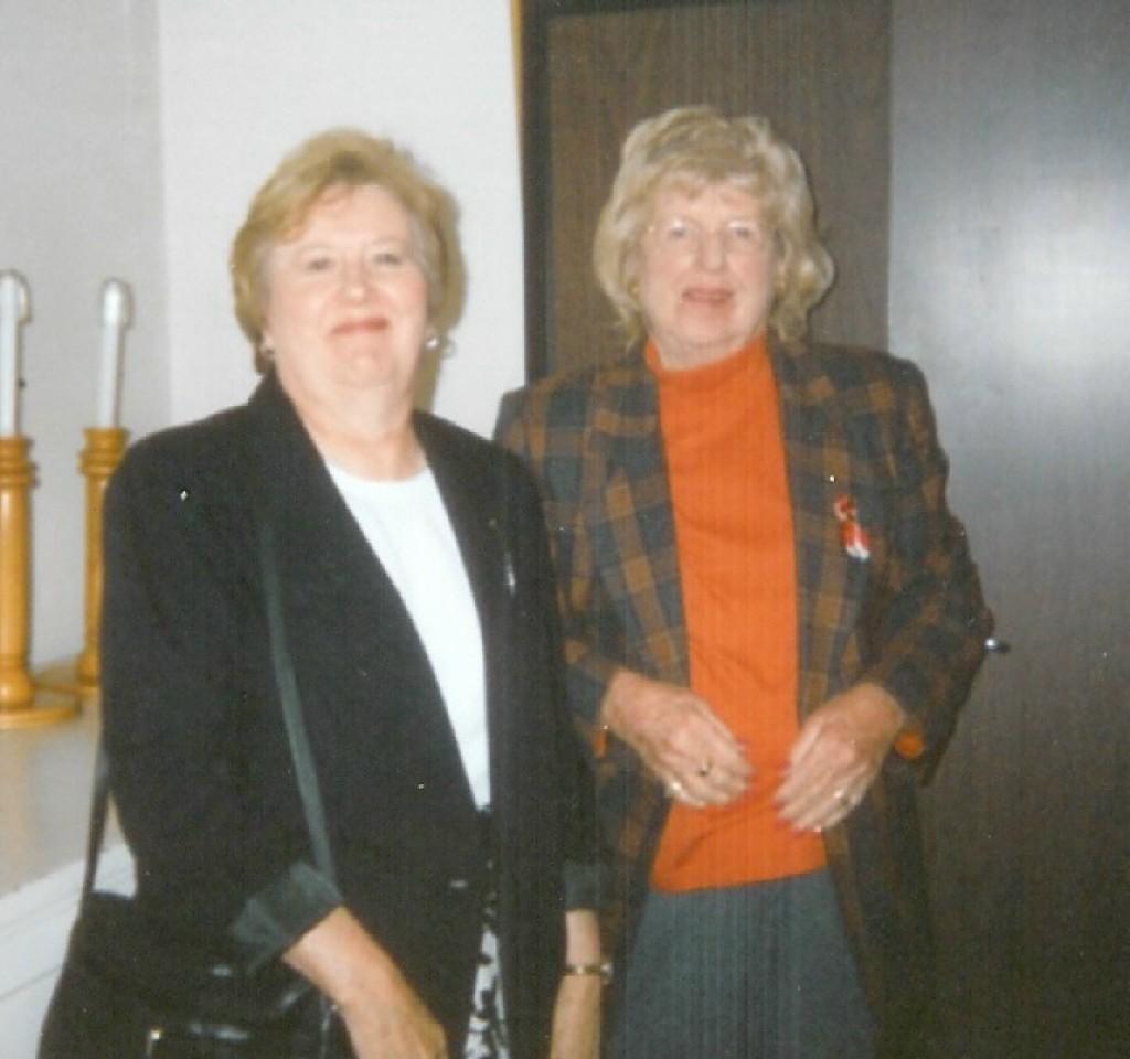 Marlene Hines and Christina Duley smile for camera while they are in the sacristy