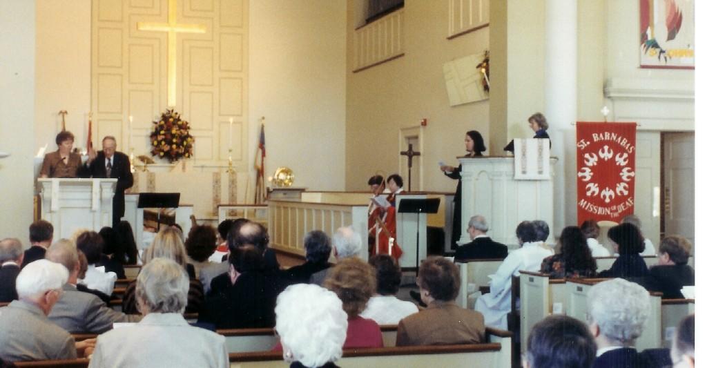 undated photo of Rudy and Marlene at the lectern of St. Johns with large congregation (Ruth Phillips' funeral?)